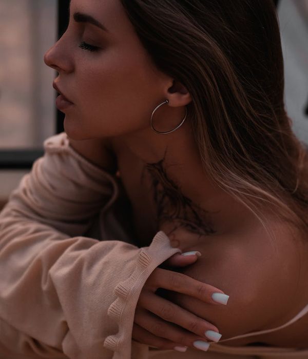 Woman in a calm yoga pose in a dark room with warm ambient light.